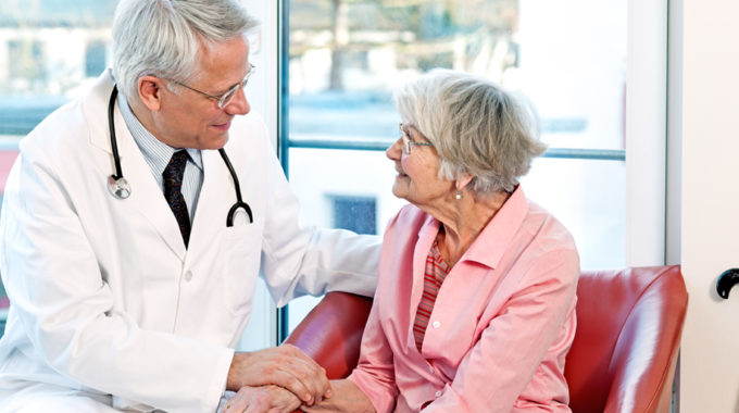 Photo Of A Doctor Having A Hospice Conversation With A Family Member.