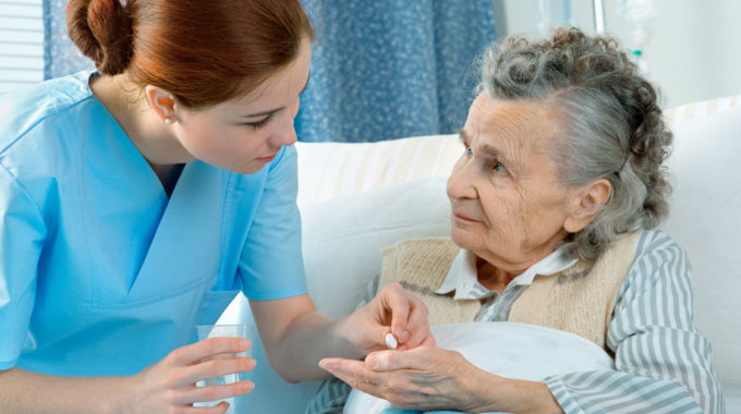 Photo Of A Nurse Providing An Opioid Pain Killer To A Hospice Patient.