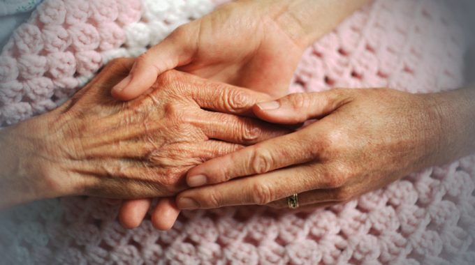Younger Person Holding Hands Of A Grandparent