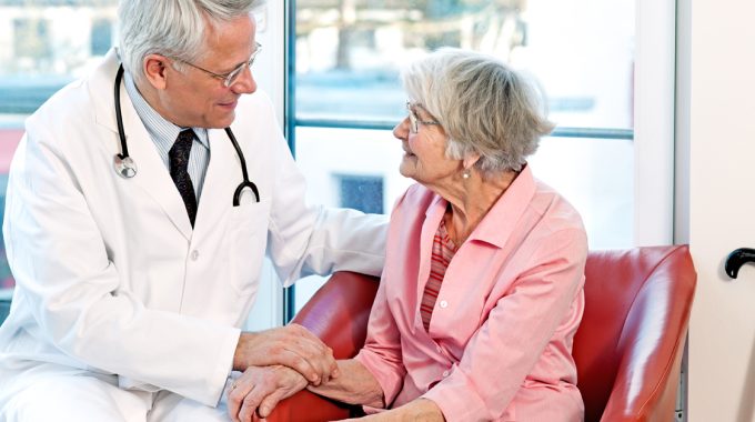 Male Doctor Conversing With A Elderly Woman About Hospice.