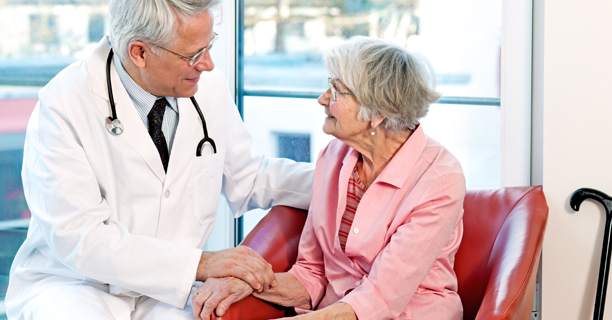 Male Doctor Conversing With A Elderly Woman About Hospice.