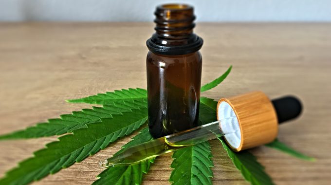 Cannabis Leave With A Dosage Dropper And Bottle