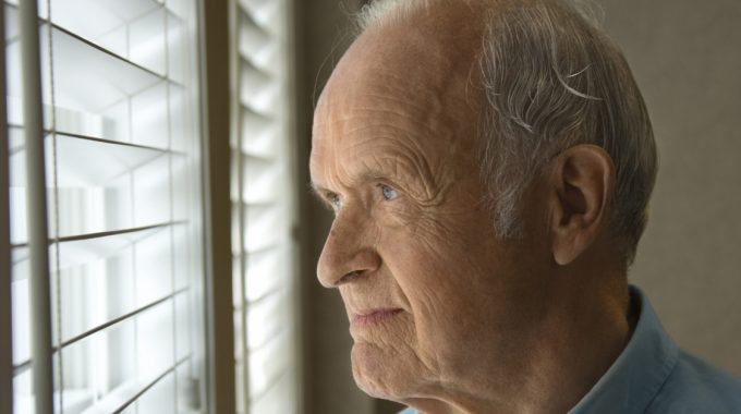 Elderly Gentleman Looking Out A Window.