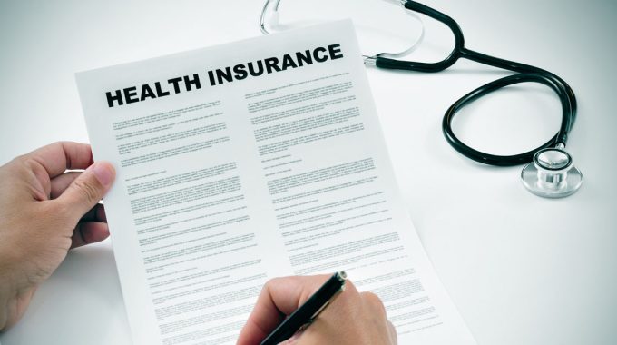 Man Signing A Health Insurance Contract