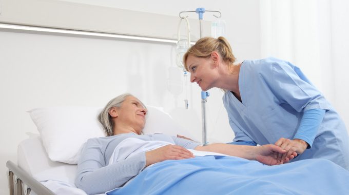 Nurse Comforting A Hospice Patient.