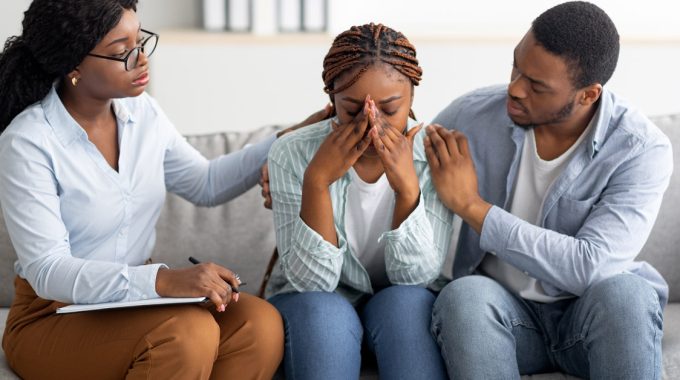 What Is A Death Doula? Social Worker Consoling A Couple In Their Home.